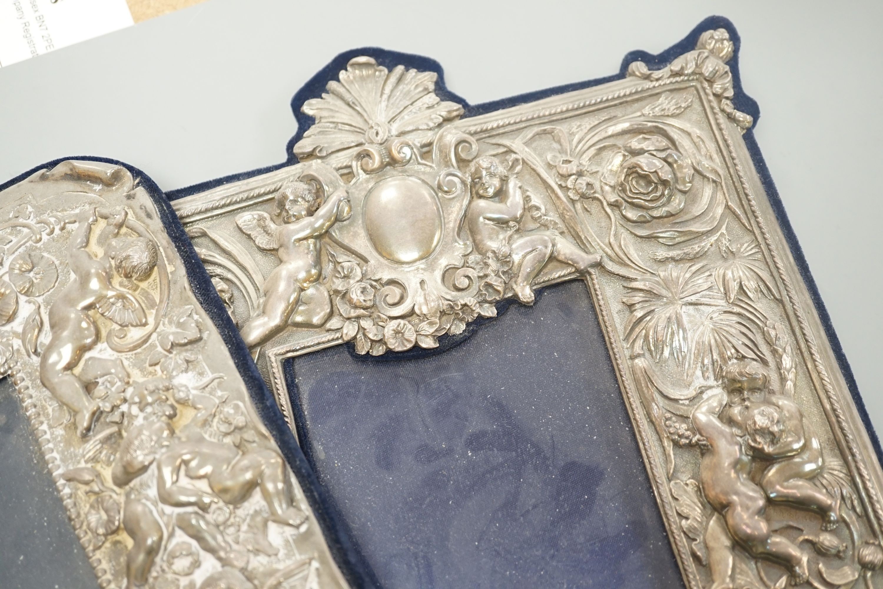 Three assorted ornate modern silver mounted photograph frames, largest overall 33.5cm.